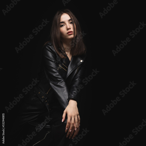 Portrait of a beautiful young woman with perfect face makeup, soft fresh healthy skin. Glamorous girl on a black background © pridneprovskiy