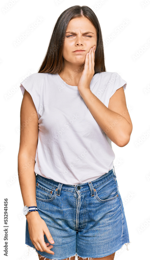 Obraz premium Young caucasian woman wearing casual white tshirt touching mouth with hand with painful expression because of toothache or dental illness on teeth. dentist