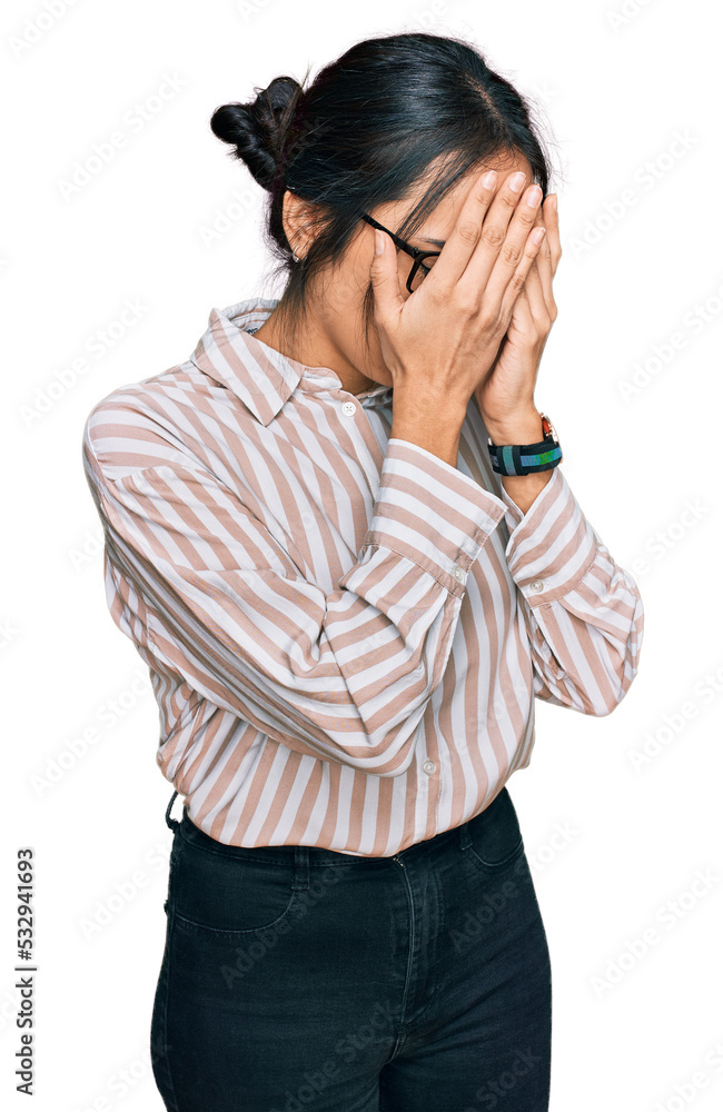 Young hispanic girl wearing casual clothes and glasses with sad expression covering face with hands while crying. depression concept. Young hispanic girl wearing casual clothes and glasses with sad expression covering face with hands while crying. depression concept.