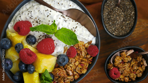 Healthy breakfast bowl with chia yogurt, crunches and fruits.