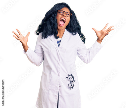 Beautiful african american optician woman with optometry glasses crazy and mad shouting and yelling with aggressive expression and arms raised. frustration concept.