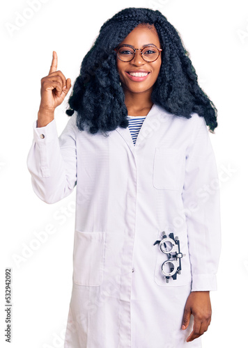 Beautiful african american optician woman with optometry glasses pointing finger up with successful idea. exited and happy. number one. photo