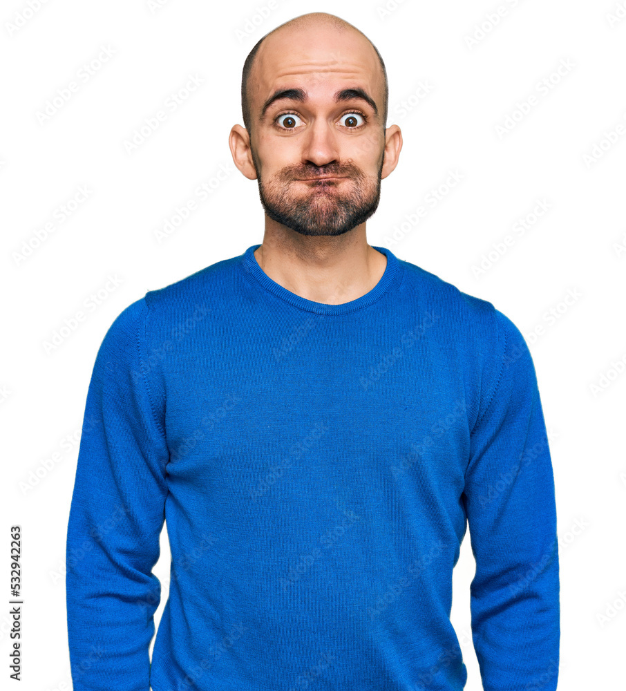 Young hispanic man wearing casual clothes puffing cheeks with funny face. mouth inflated with air, crazy expression. Young hispanic man wearing casual clothes puffing cheeks with funny face. mouth inflated with air, crazy expression.