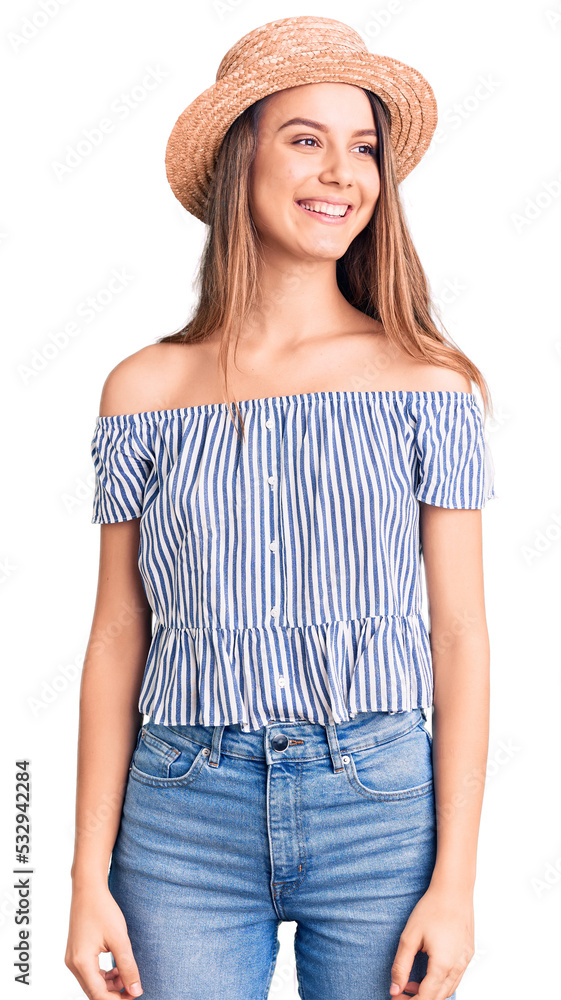Young beautiful girl wearing hat and t shirt looking away to side with smile on face, natural expression. laughing confident. Young beautiful girl wearing hat and t shirt looking away to side with smile on face, natural expression. laughing confident.