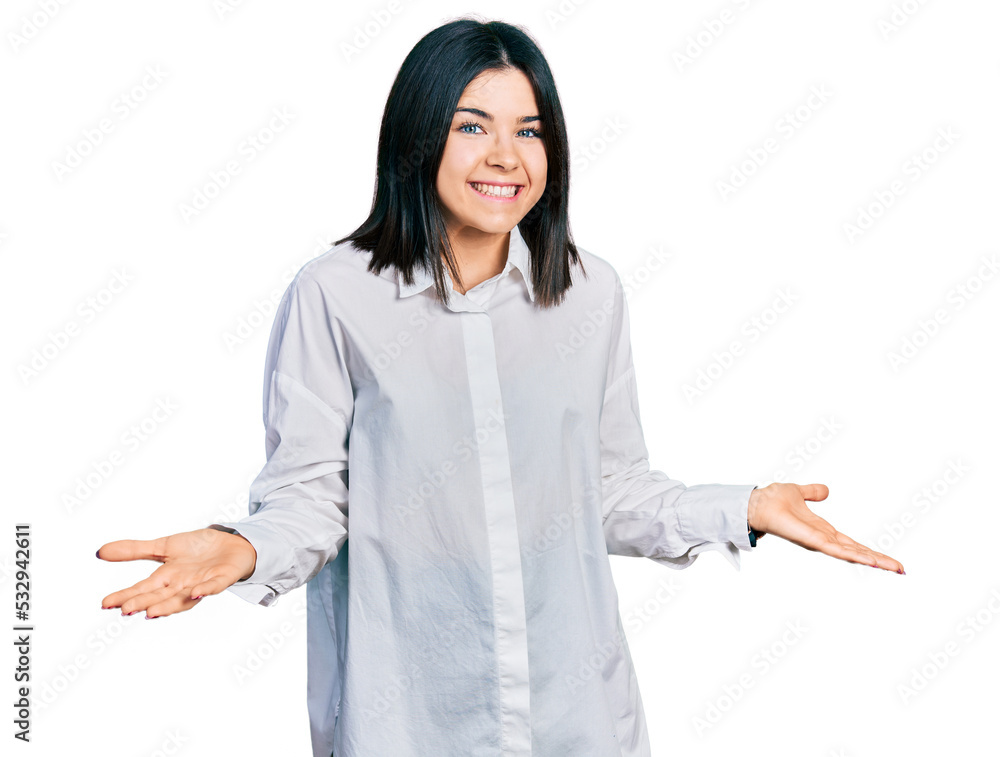 Young brunette woman with blue eyes wearing oversize white shirt smiling cheerful with open arms as friendly welcome, positive and confident greetings Young brunette woman with blue eyes wearing oversize white shirt smiling cheerful with open arms as friendly welcome, positive and confident greetings