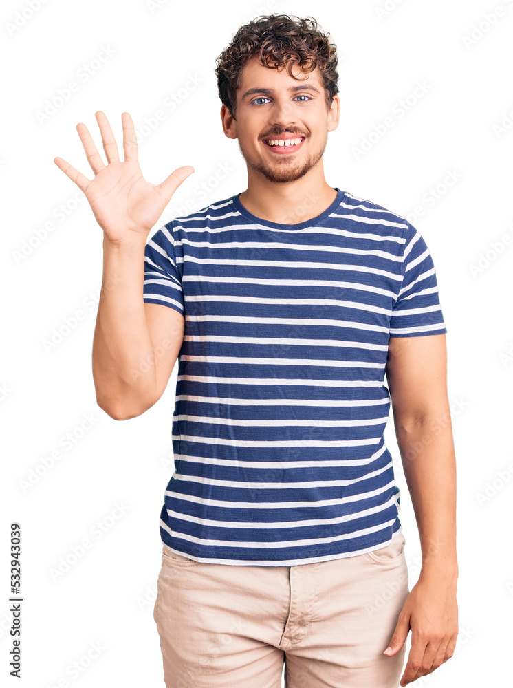 Young handsome man with curly hair wearing casual clothes showing and pointing up with fingers number five while smiling confident and happy. Young handsome man with curly hair wearing casual clothes showing and pointing up with fingers number five while smiling confident and happy.