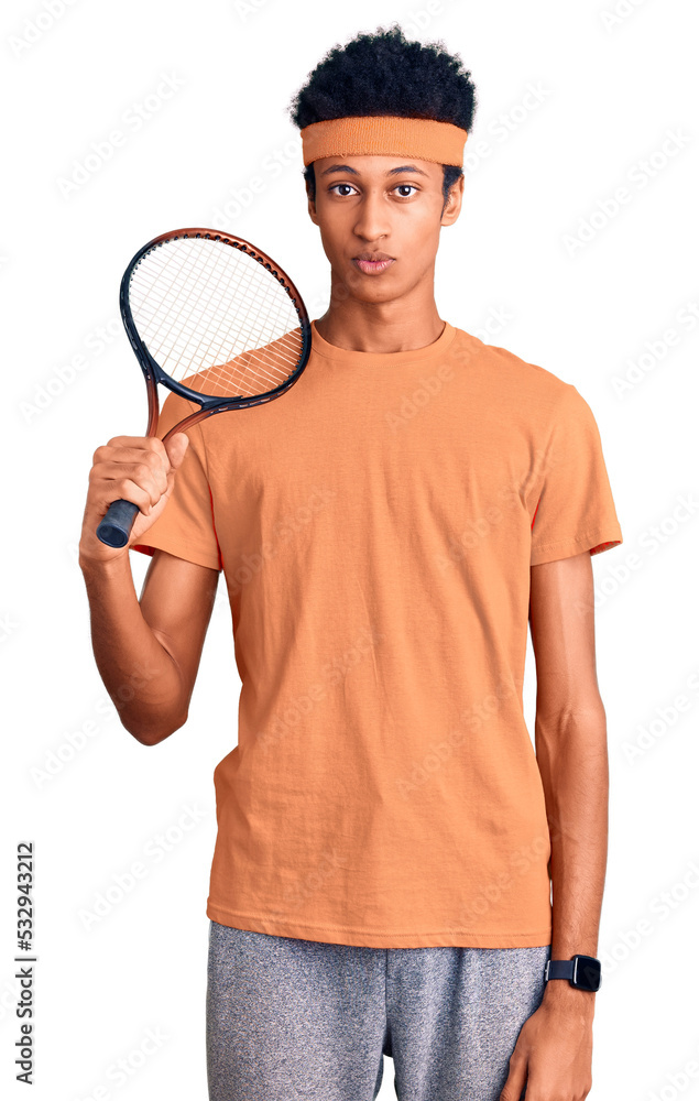 Young african american man playing tennis holding racket thinking attitude and sober expression looking self confident Young african american man playing tennis holding racket thinking attitude and sober expression looking self confident