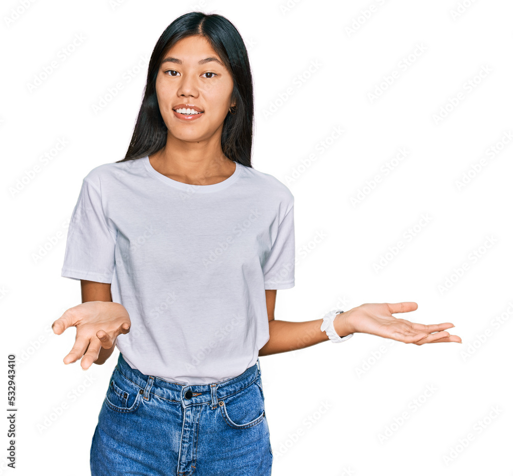 Beautiful young asian woman wearing casual white t shirt smiling cheerful with open arms as friendly welcome, positive and confident greetings Beautiful young asian woman wearing casual white t shirt smiling cheerful with open arms as friendly welcome, positive and confident greetings