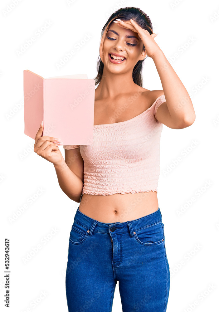 Young beautiful woman holding book stressed and frustrated with hand on head, surprised and angry face Young beautiful woman holding book stressed and frustrated with hand on head, surprised and angry face