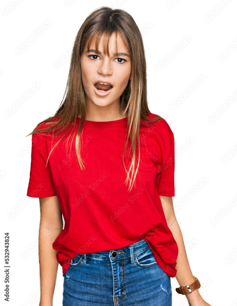 Teenager caucasian girl wearing casual red t shirt in shock face, looking skeptical and sarcastic, surprised with open mouth Teenager caucasian girl wearing casual red t shirt in shock face, looking skeptical and sarcastic, surprised with open mouth