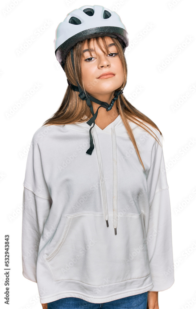 Teenager caucasian girl wearing bike helmet relaxed with serious expression on face. simple and natural looking at the camera. Teenager caucasian girl wearing bike helmet relaxed with serious expression on face. simple and natural looking at the camera.