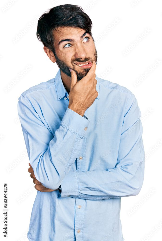 Hispanic man with blue eyes wearing business shirt thinking worried about a question, concerned and nervous with hand on chin Hispanic man with blue eyes wearing business shirt thinking worried about a question, concerned and nervous with hand on chin