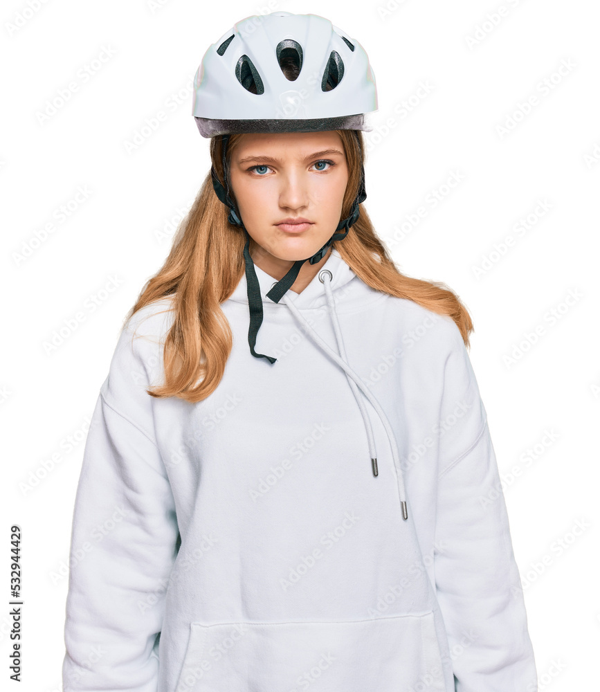 Beautiful young caucasian girl wearing bike helmet with serious expression on face. simple and natural looking at the camera. Beautiful young caucasian girl wearing bike helmet with serious expression on face. simple and natural looking at the camera.