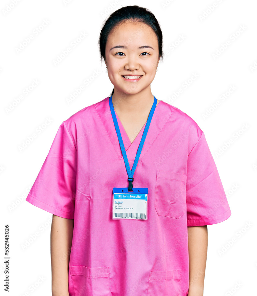 Young chinese woman wearing pink nurse uniform with a happy and cool smile on face. lucky person. Young chinese woman wearing pink nurse uniform with a happy and cool smile on face. lucky person.