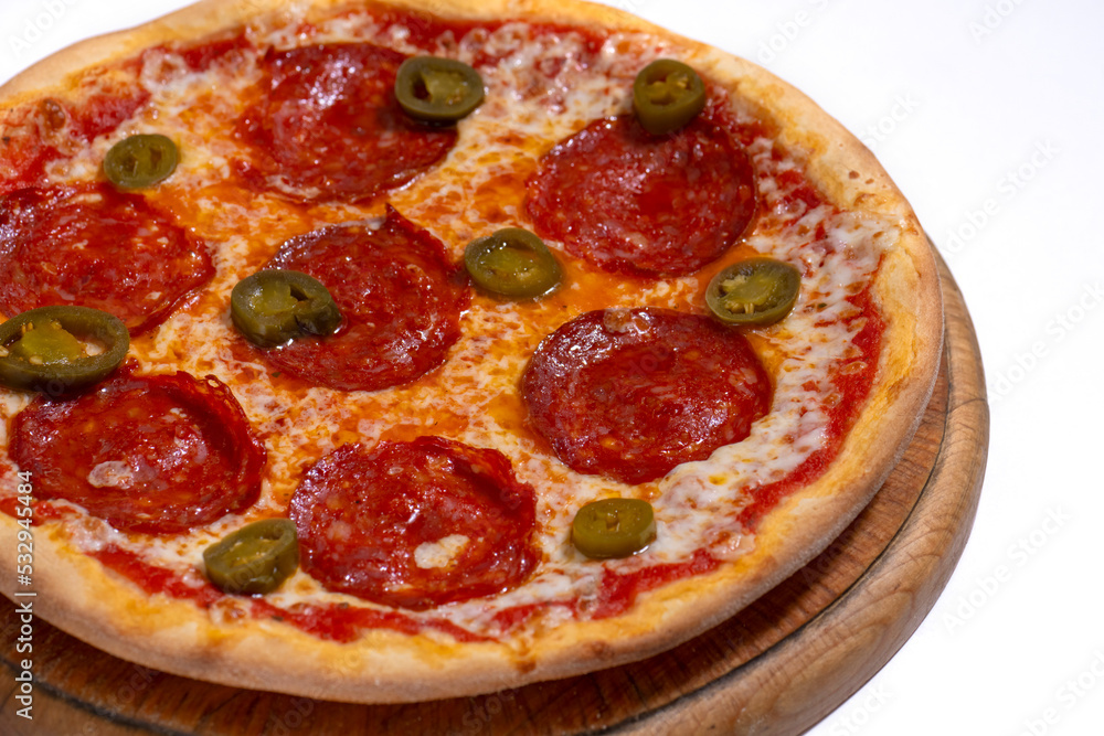 Closeup of pizza with pepperoni and jalapeno pepper Closeup of pizza with pepperoni and jalapeno pepper
