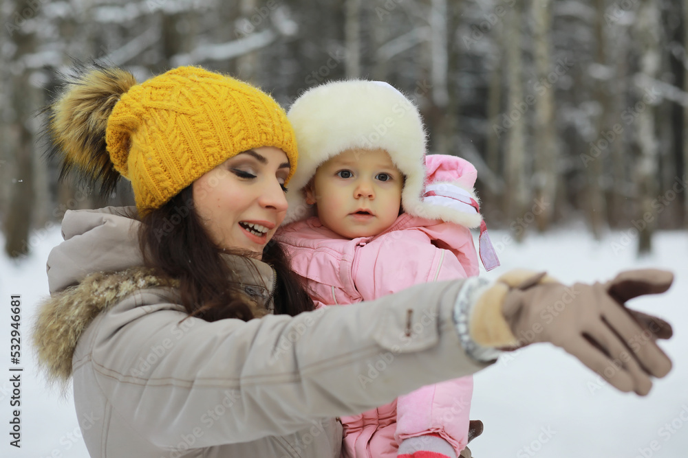 Obraz premium Happy family playing and laughing in winter outdoors in the snow. City park winter day.