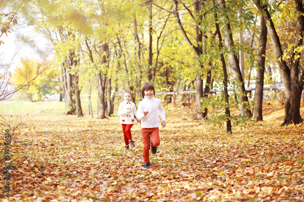 Young family on a walk in the autumn park on a sunny day. Happiness to be together. Young family on a walk in the autumn park on a sunny day. Happiness to be together.