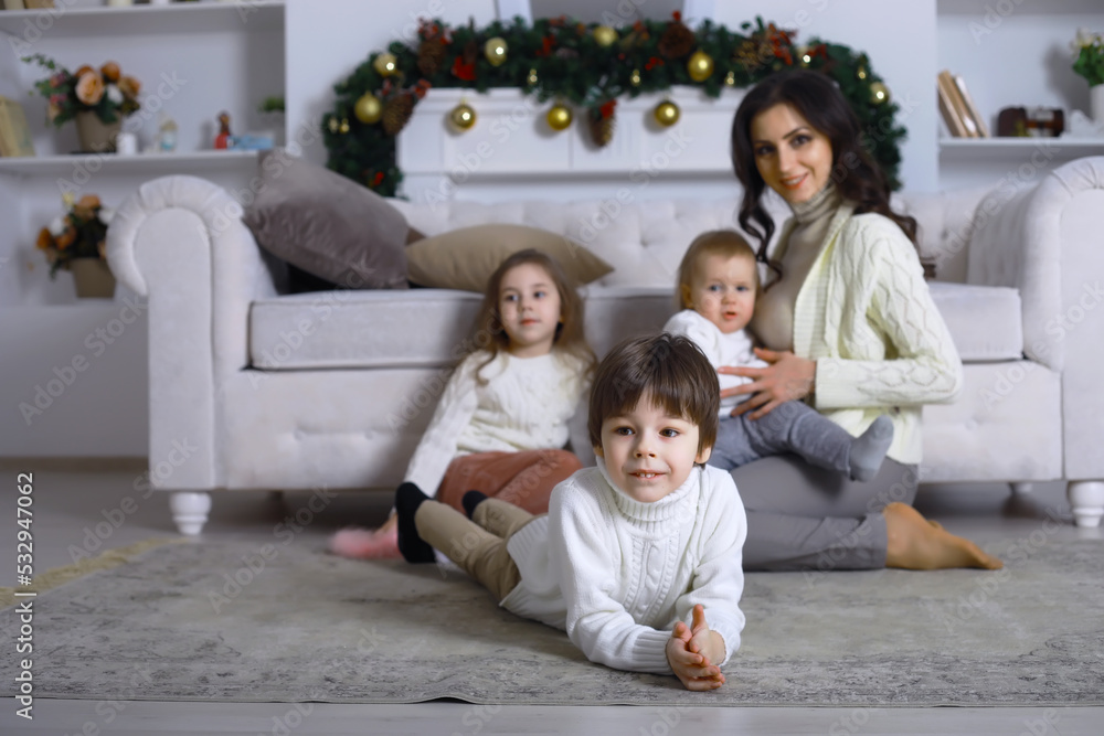 A young family with children decorates the house for the holiday. New Years Eve. Waiting for the new year. A young family with children decorates the house for the holiday. New Years Eve. Waiting for the new year.