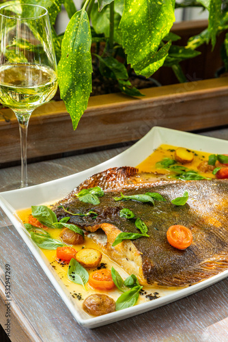 sea delicacy, sea food, fried flounder with vegetables, served with white wine