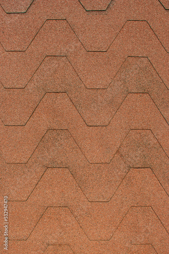 Close up view on asphalt roofing shingles background texture.