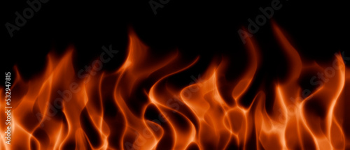 Bright flames of fire on a black background, realistic abstract flames.