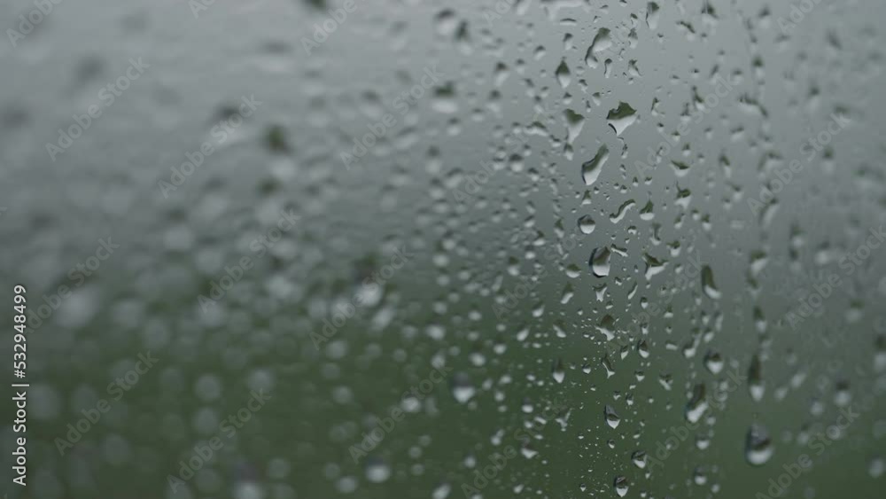 Real background of rain hitting glass window Real background of rain hitting glass window