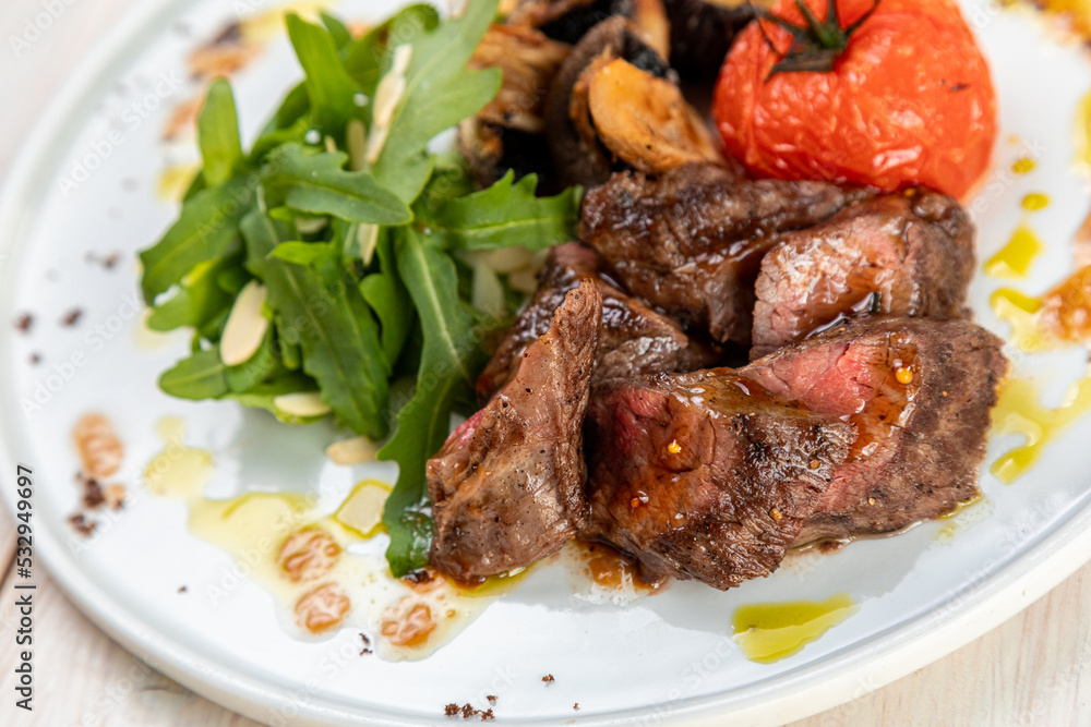 barbecue with grilled vegetables with fresh herbs on a white plate barbecue with grilled vegetables with fresh herbs on a white plate