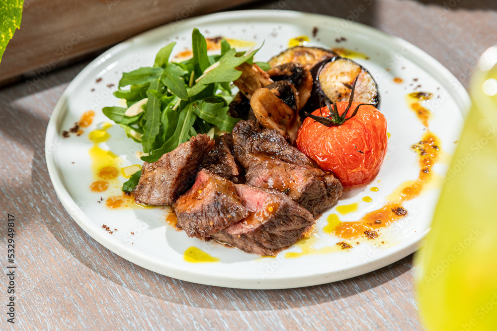 barbecue with grilled vegetables with fresh herbs on a white plate barbecue with grilled vegetables with fresh herbs on a white plate