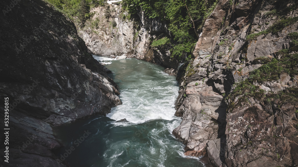 Beautiful mountain river in the canyon. Fast current. Beautiful nature and forests. Trees grow on the mountains. Beautiful mountain river in the canyon. Fast current. Beautiful nature and forests. Trees grow on the mountains.