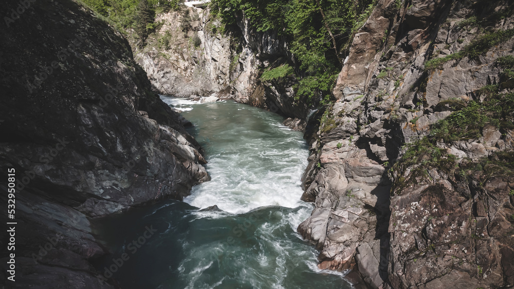 Beautiful mountain river in the canyon. Fast current. Beautiful nature and forests. Trees grow on the mountains.