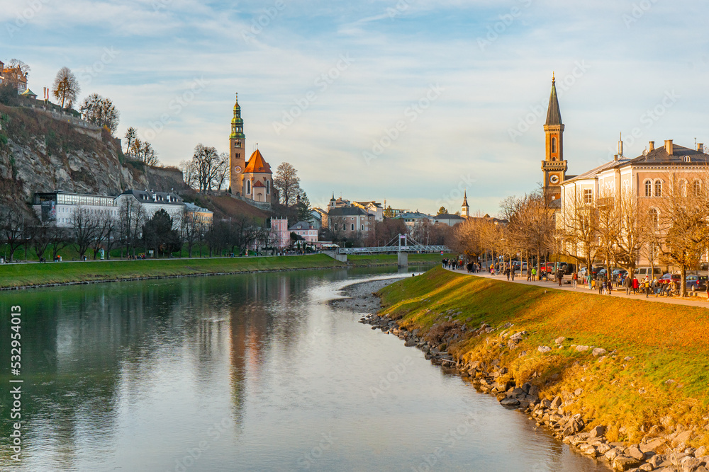 Fototapeta premium Panoramic and Mulln Church along Salzach river near Marko Feingold Steg , Hohensalzburg during autumn , winter : Salzburg , Austria : December 9 , 2019