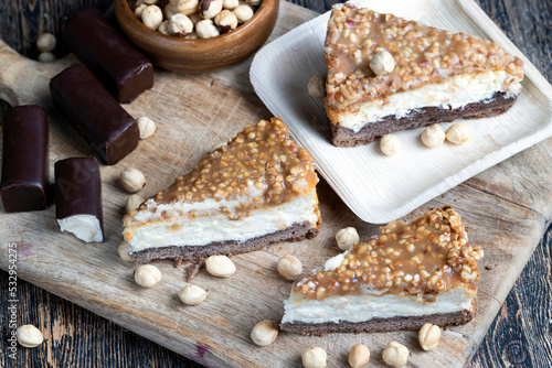 A piece of cheesecake cake with roasted peanuts in caramel