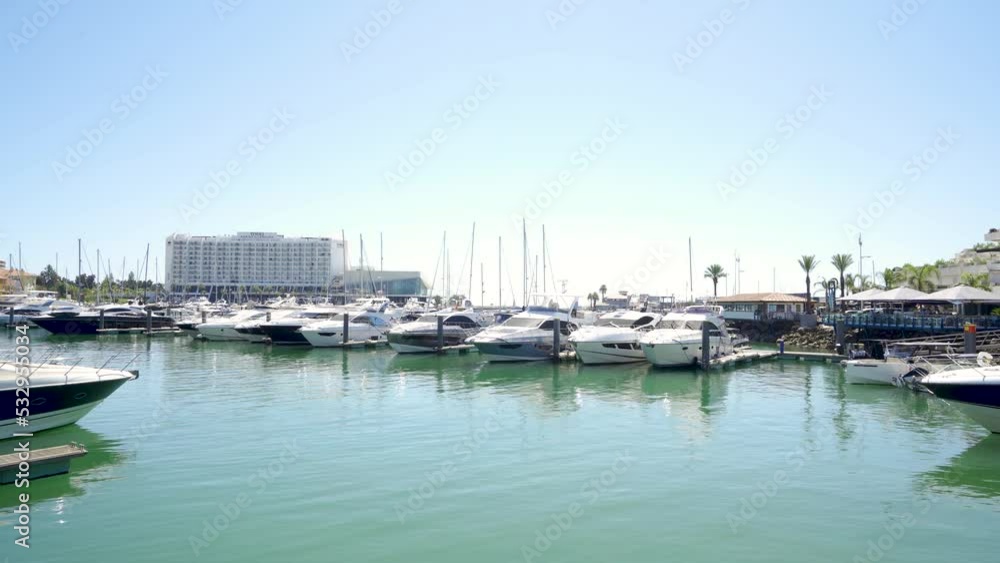 Vilamoura, PORTUGAL: September 18 2022: View of luxury port of Vilamoura. Algarve region. Luxury travel destination in South of Portugal. Yacht docked, restaurants, luxury hotels and urbanisations. Vilamoura, PORTUGAL: September 18 2022: View of luxury port of Vilamoura. Algarve region. Luxury travel destination in South of Portugal. Yacht docked, restaurants, luxury hotels and urbanisations.