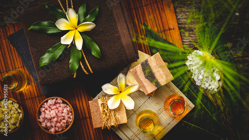 Spa and Wellness Treatment Decorations accessories Inspirations with herbal, sponge scrub, aroma candles, plumeria frangipani flowers, and towels, for body and skin care therapy and relaxation