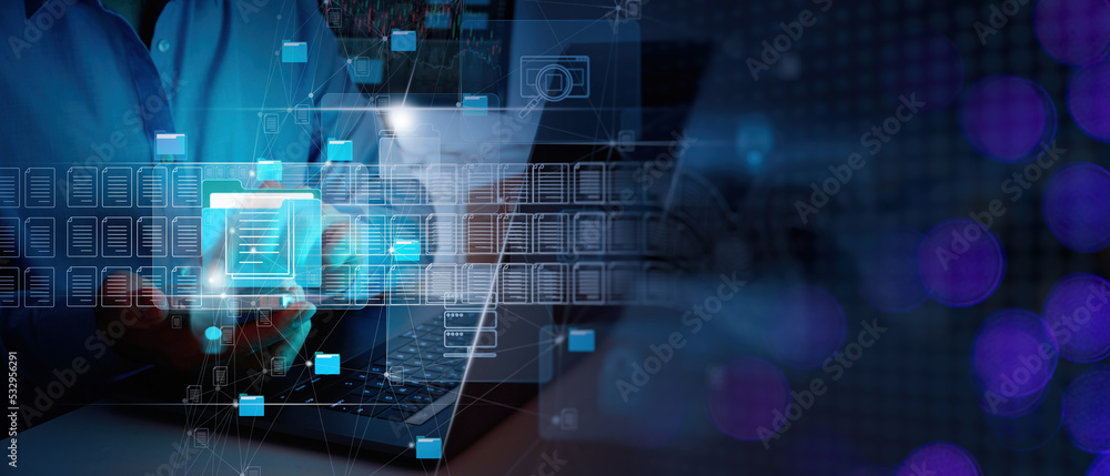 ERP, document management concept.Businessman working with smart phone and laptop computer with icons on virtual screen and office blur background.