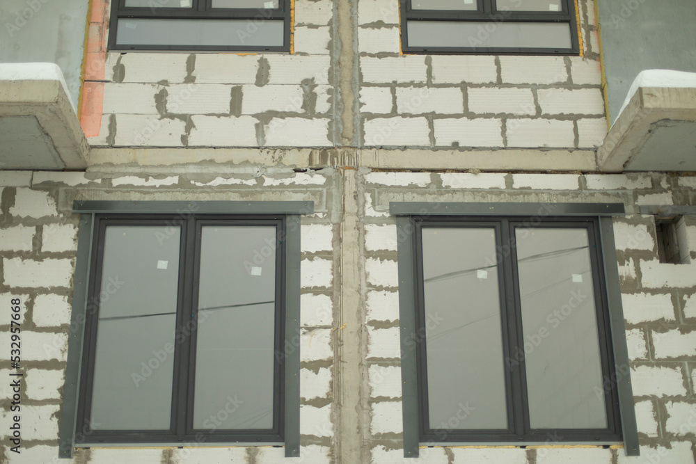 Windows in building. Unfinished house. Windows in building. Unfinished house.