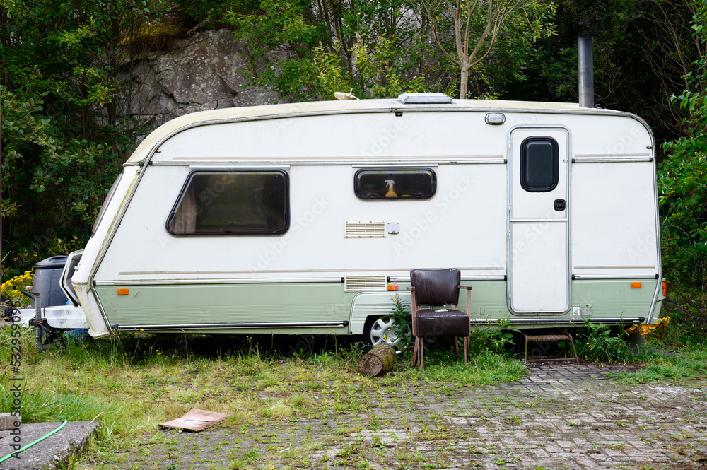 Caravan abandoned and dumped in park waiting to be removed