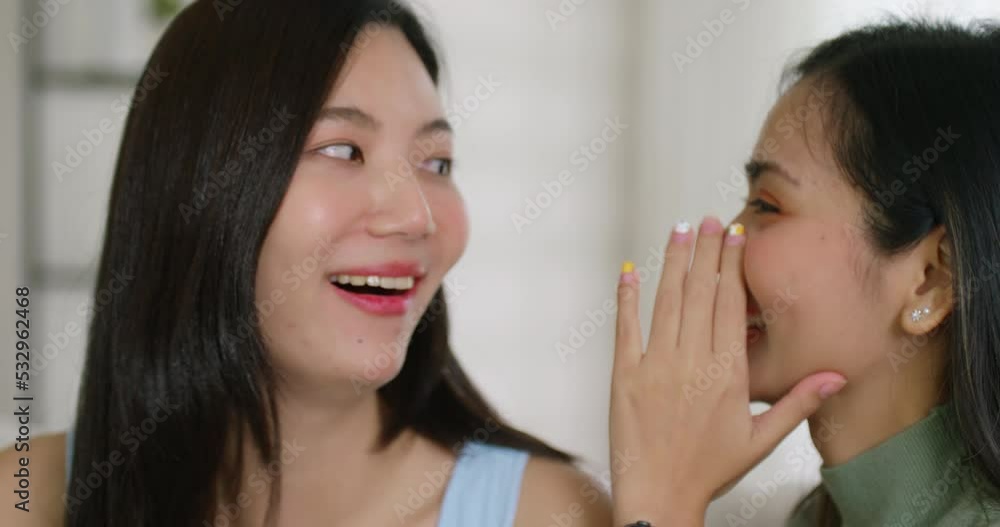 Gen Z asia people gay LGBT girl friend tell fun good news at ear happy overjoy. Open mouth amazed shock face in young adult asian couple lady listen black Friday sale rumor gossip laugh smile at home. Gen Z asia people gay LGBT girl friend tell fun good news at ear happy overjoy. Open mouth amazed shock face in young adult asian couple lady listen black Friday sale rumor gossip laugh smile at home.