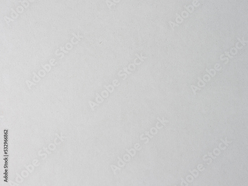 White cardboard texture as an abstract background. Fine structure in a white color. Detailed paper material with dust on it. Dirty surface of a blank pattern with vertical lines.