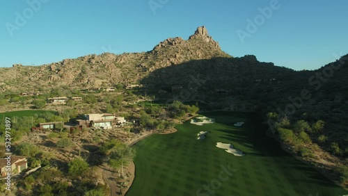 Scottsdale golf course and mountains aerial at sunset front lit with Pinnacle Peak in background photo