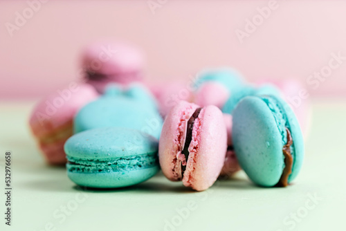 Close-up of macarons cakes of different colors in pastel color background. Culinary and cooking concept. Tasty colourful macaroons