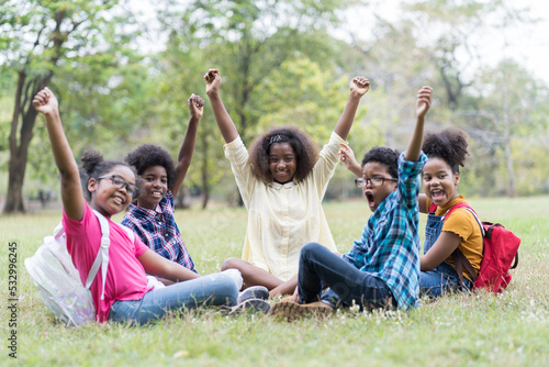 Group of African American children learning outdoor in the park. Diversity black people learning outside the classroom. Kids field trips outside. Kids and educational concept