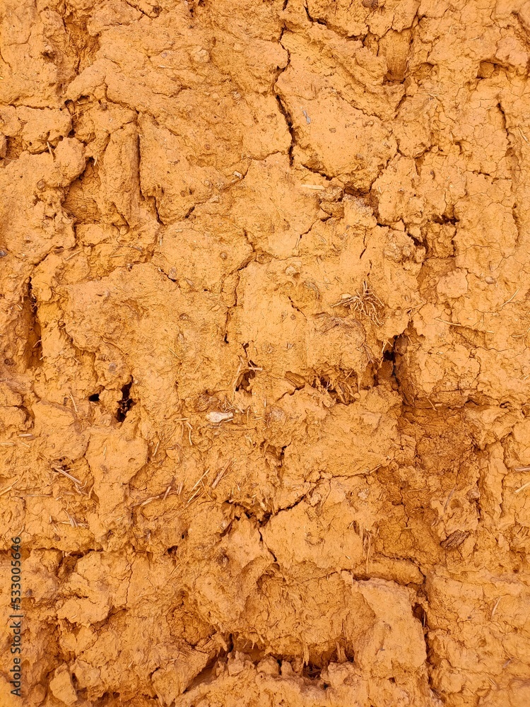 An old clay wall. Abstract textured background of red color. An old clay wall. Abstract textured background of red color.