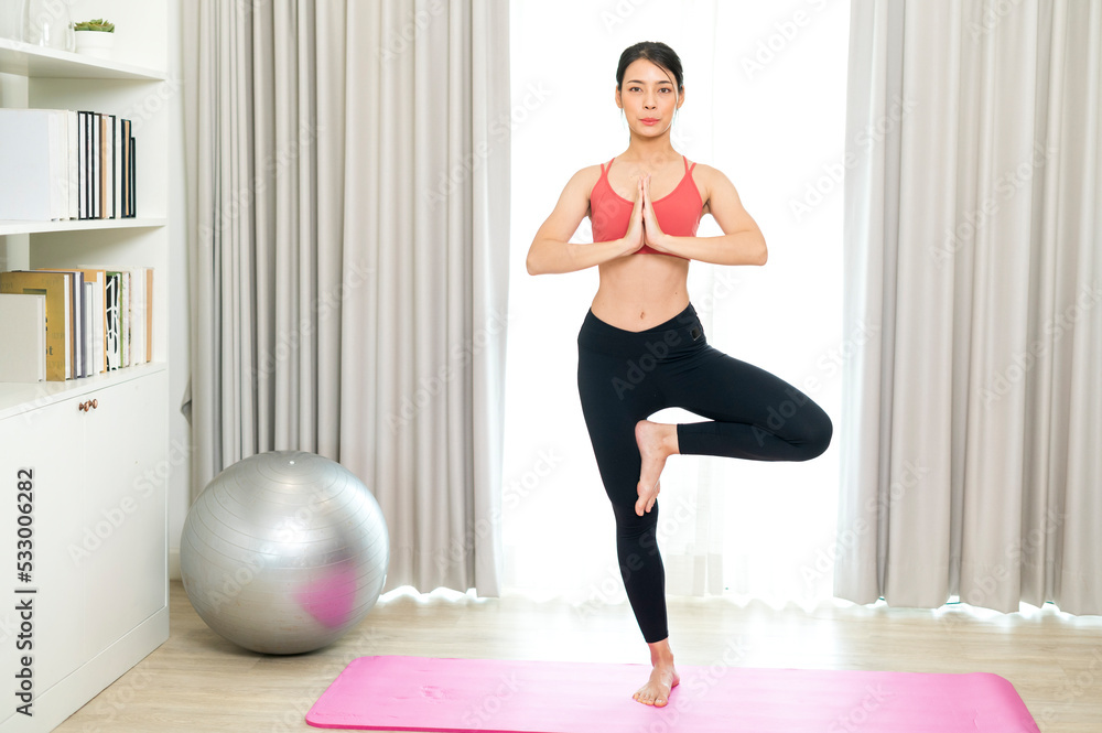 Obraz premium Young and Strong attractive fitness woman in sportswear exercise on yoga mat in gym - Healthy lifestyle training Concept.
