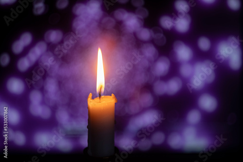 burning candle on bokeh background, blurred background
