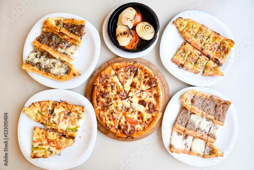 Delicious mixed pizza with rich content. Menu concept of choice and diversity. Sucuklu, Mantarli, karisik, akdeniz pizza