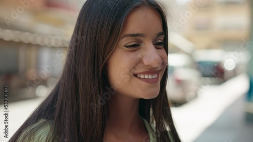 Wallpaper Mural Young beautiful hispanic woman smiling confident looking to the side at street Torontodigital.ca