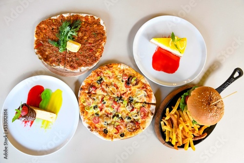 Traditional Turkish cuisine. Pizza  pita  pidesi  sucuk  hummus  kebab. Many dishes on the table. Serving dishes in restaurant. Background image. Top view  flat lay