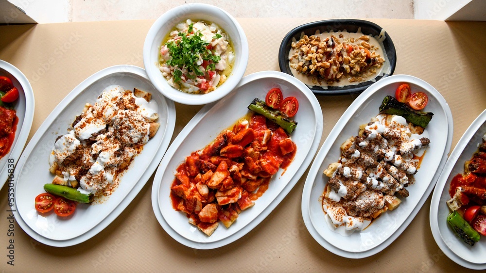 Table scene of assorted take out or delivery foods. Traditional Turkish cuisine. Various Turkish meal and appetizers. Top down view on a table. Table scene of assorted take out or delivery foods. Traditional Turkish cuisine. Various Turkish meal and appetizers. Top down view on a table.