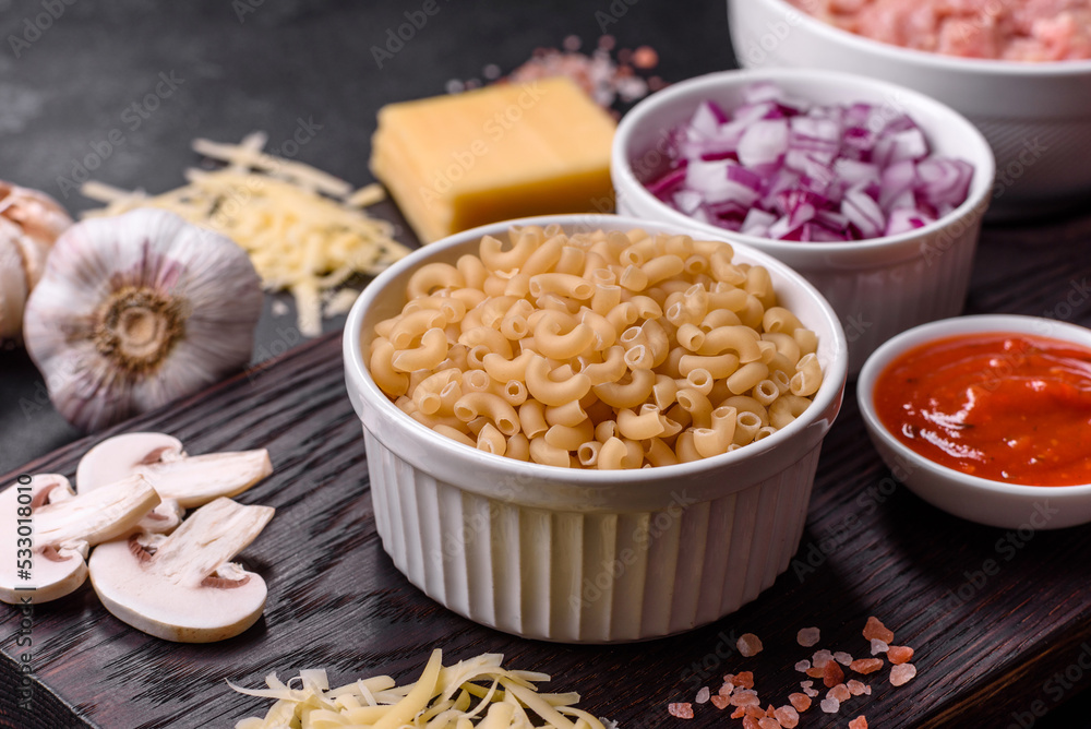 Raw pasta, mushrooms, onions, mince, spices and herbs to make a delicious paste Raw pasta, mushrooms, onions, mince, spices and herbs to make a delicious paste